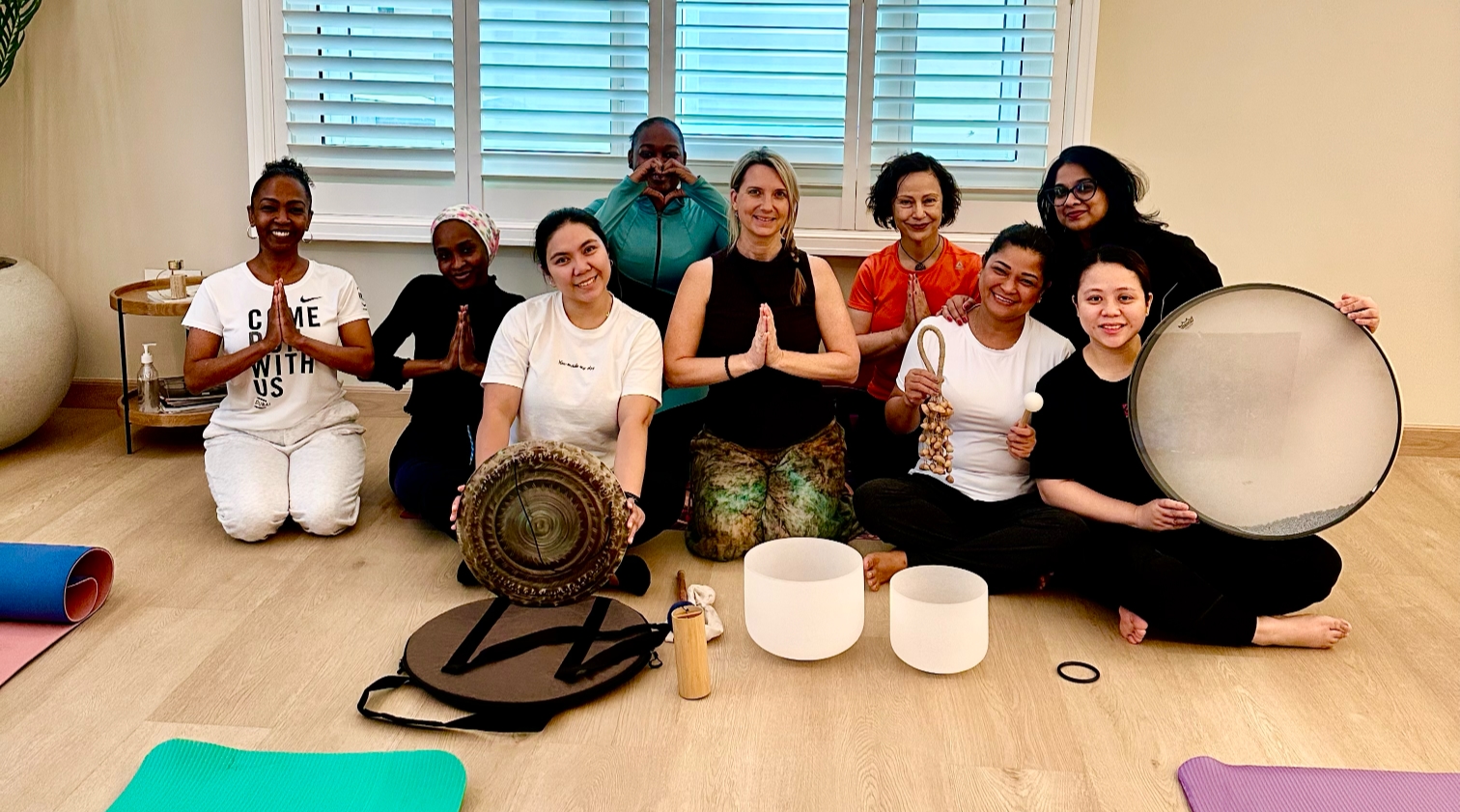 Sound healing training course with students learning crystal bowls and meditation techniques